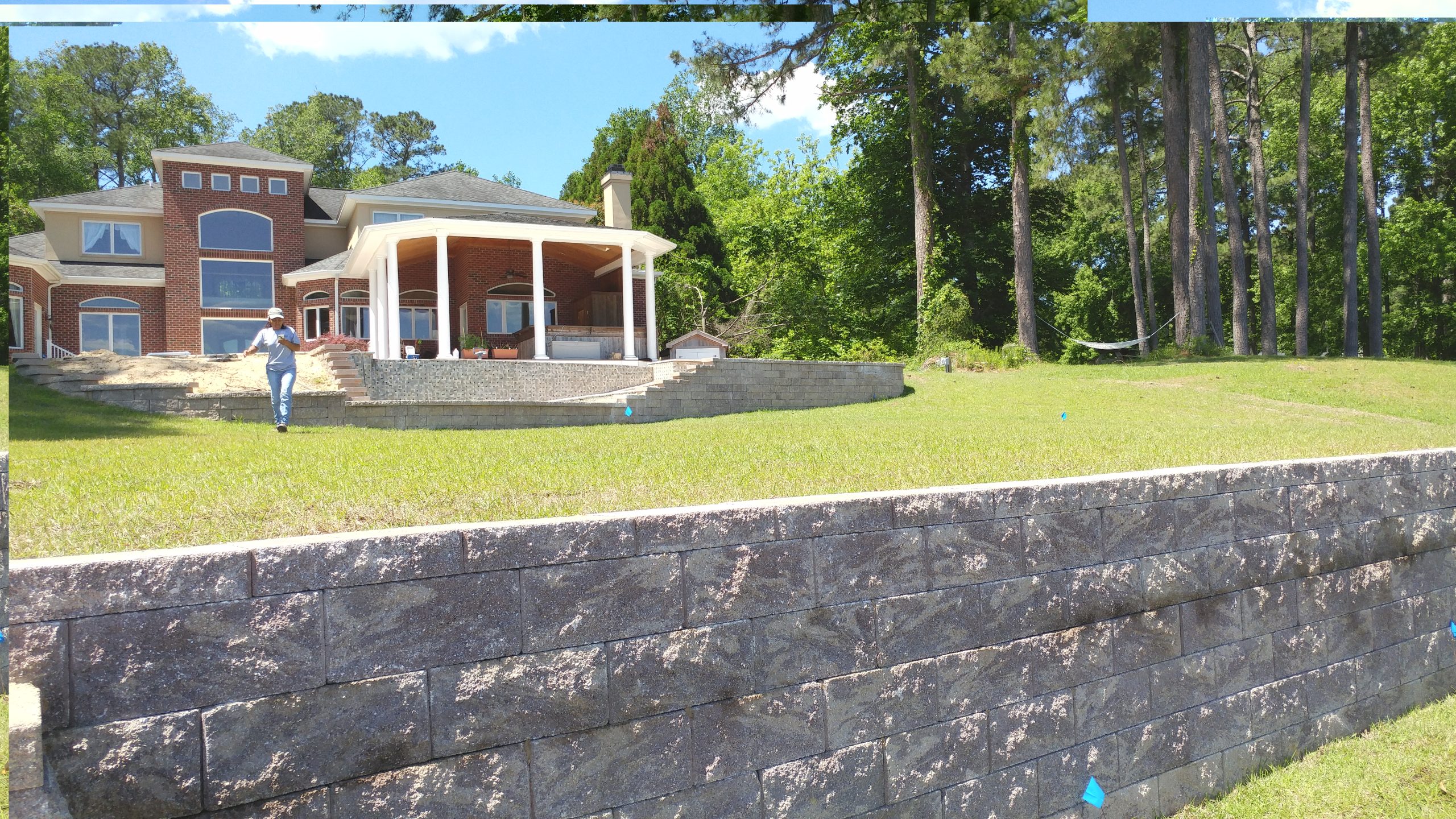Retaining Walls, Travertine Pool Deck Pavers, and Centipede Sod.